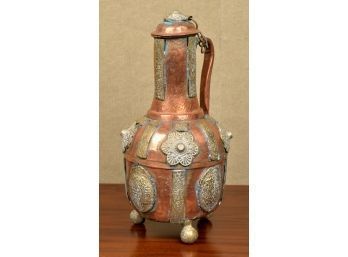 A heavy copper and brass lidded