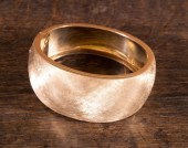 A HEAVY GOLD HINGED BANGLE BRA