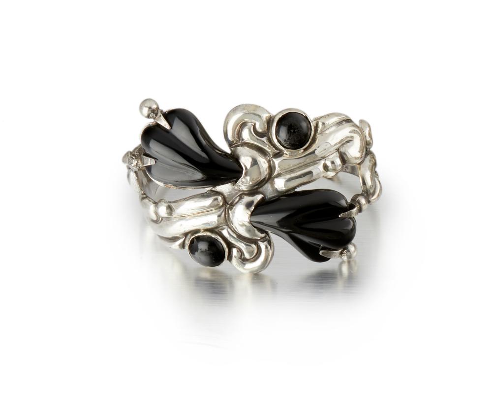 A HECTOR AGUILAR SILVER AND BLACK