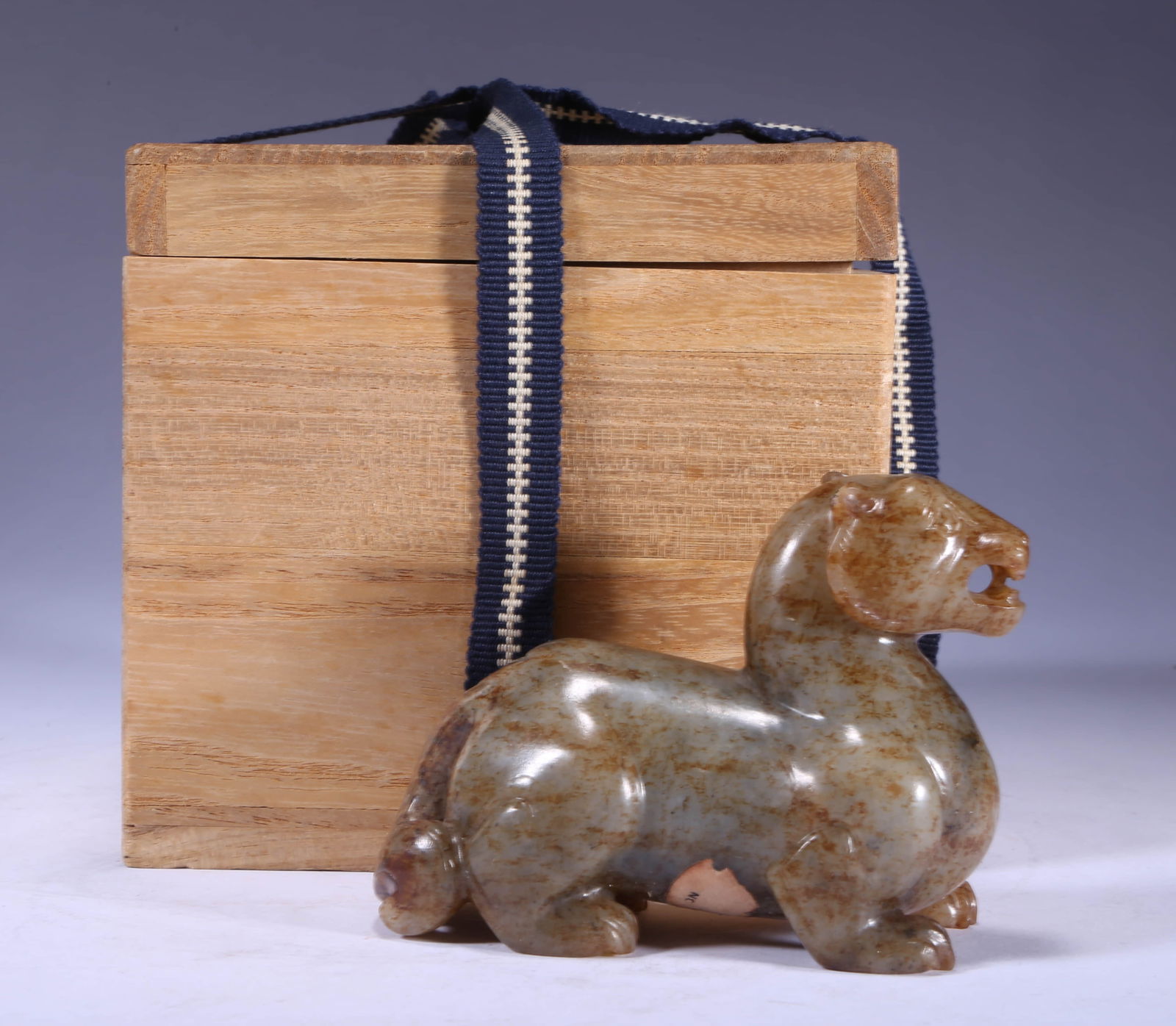 A HETIAN JADE BEAST STATUETTEA