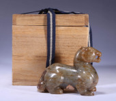 A HETIAN JADE BEAST STATUETTE<