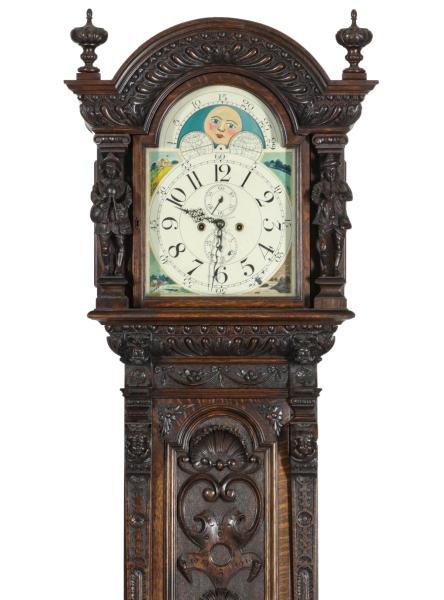 A HIGHLY CARVED OAK LONG CASE CLOCK
