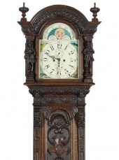 A HIGHLY CARVED OAK LONG CASE