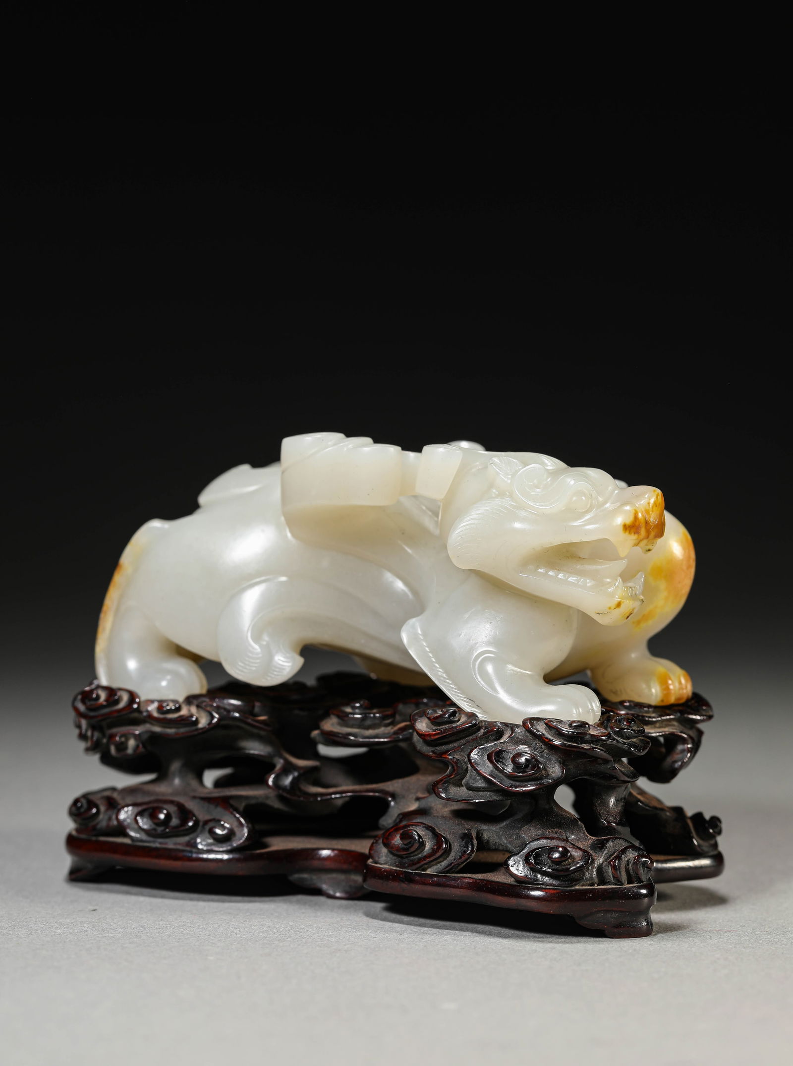 A JADE CARVING OF A MYTHICAL BEASTA