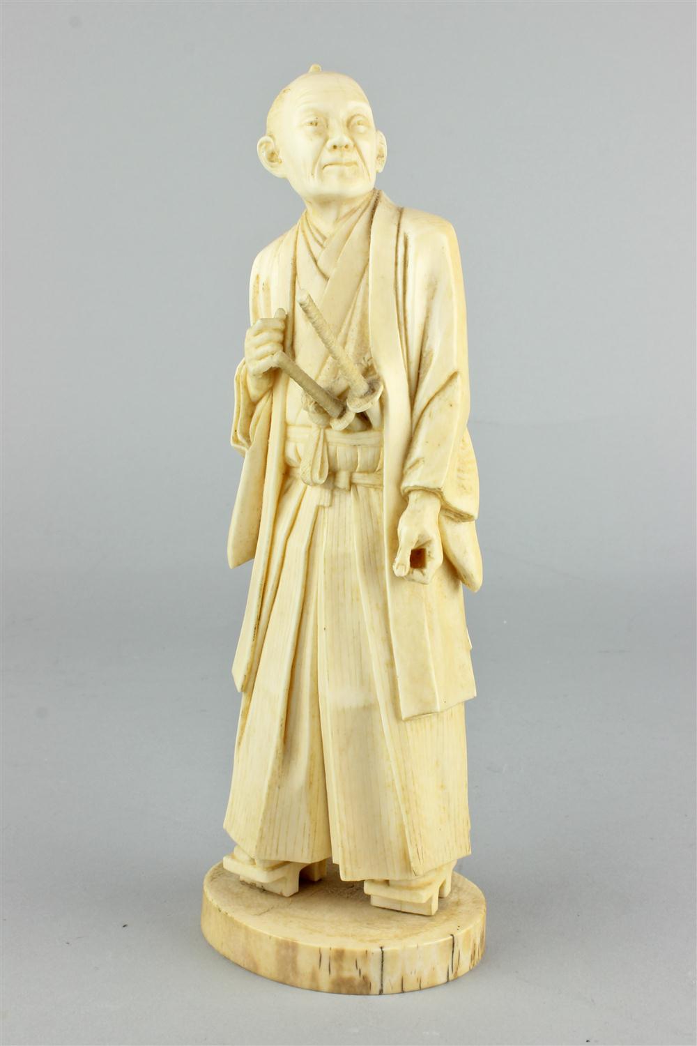 A JAPANESE CARVED IVORY FIGURE OF