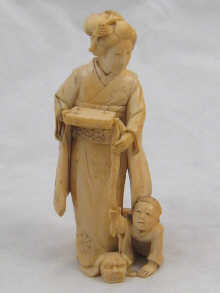 A Japanese carved ivory figure of
