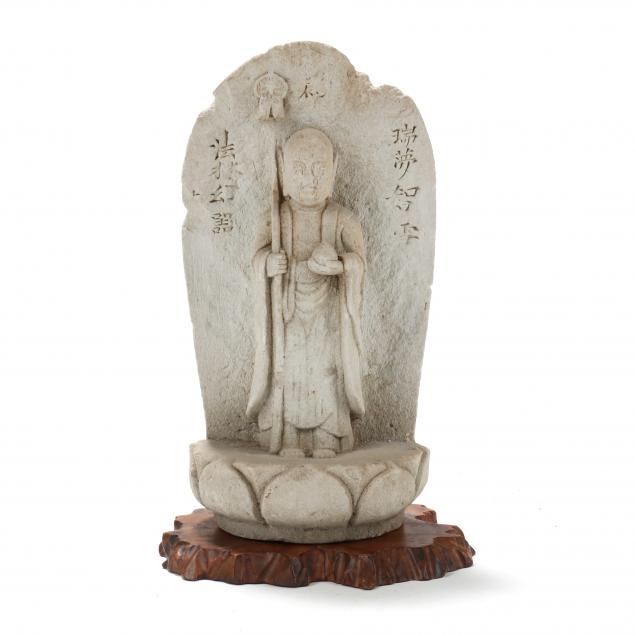 A JAPANESE CARVED STONE SCULPTURE