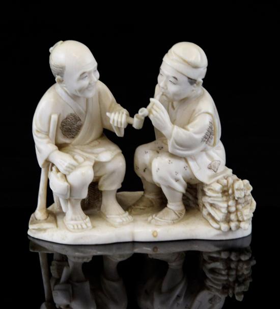 A Japanese ivory group of two