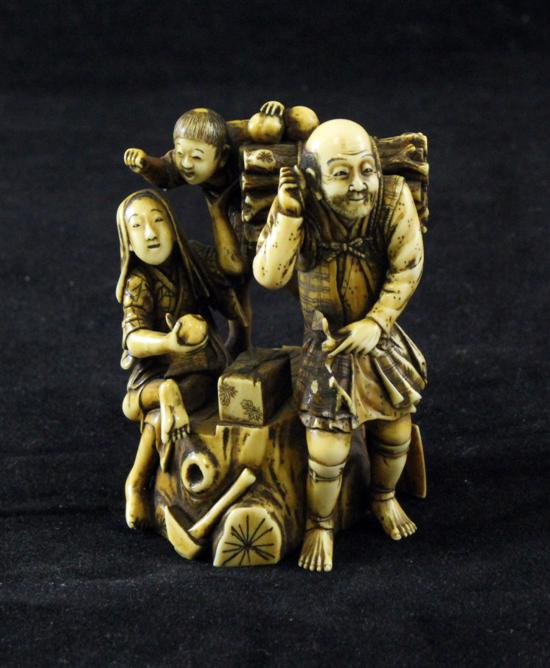 A Japanese stained ivory group of a