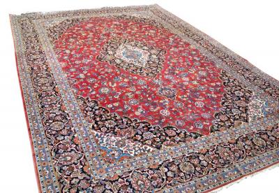 A Kashan carpet, the red field with