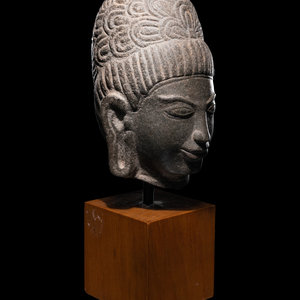 A Khmer Stone Head of Deity bearing