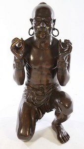 A KNEELING BRONZE FIGURE OF MA