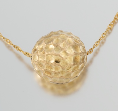 A Ladies' Golf Ball Pendant on