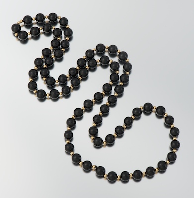 A Ladies' Onyx and Gold Bead