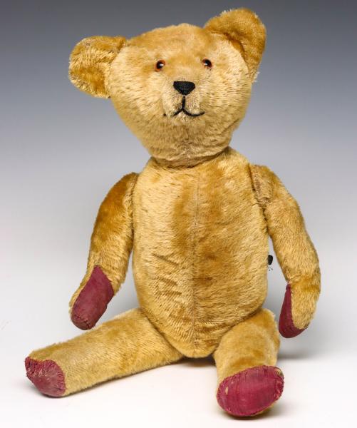 A LARGE ANTIQUE GOLD MOHAIR TEDDY