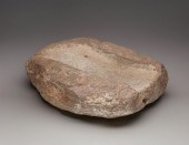 A LARGE CARVED STONE METATEA l