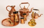 A large copper kettle with bra
