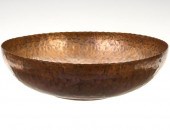A LARGE HAMMERED COPPER BASIN