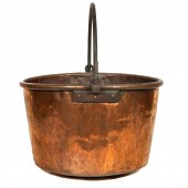 A LARGE HAMMERED COPPER LOG BI