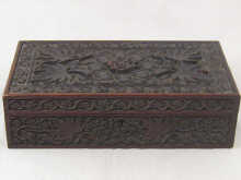 A large heavily carved wooden cigar