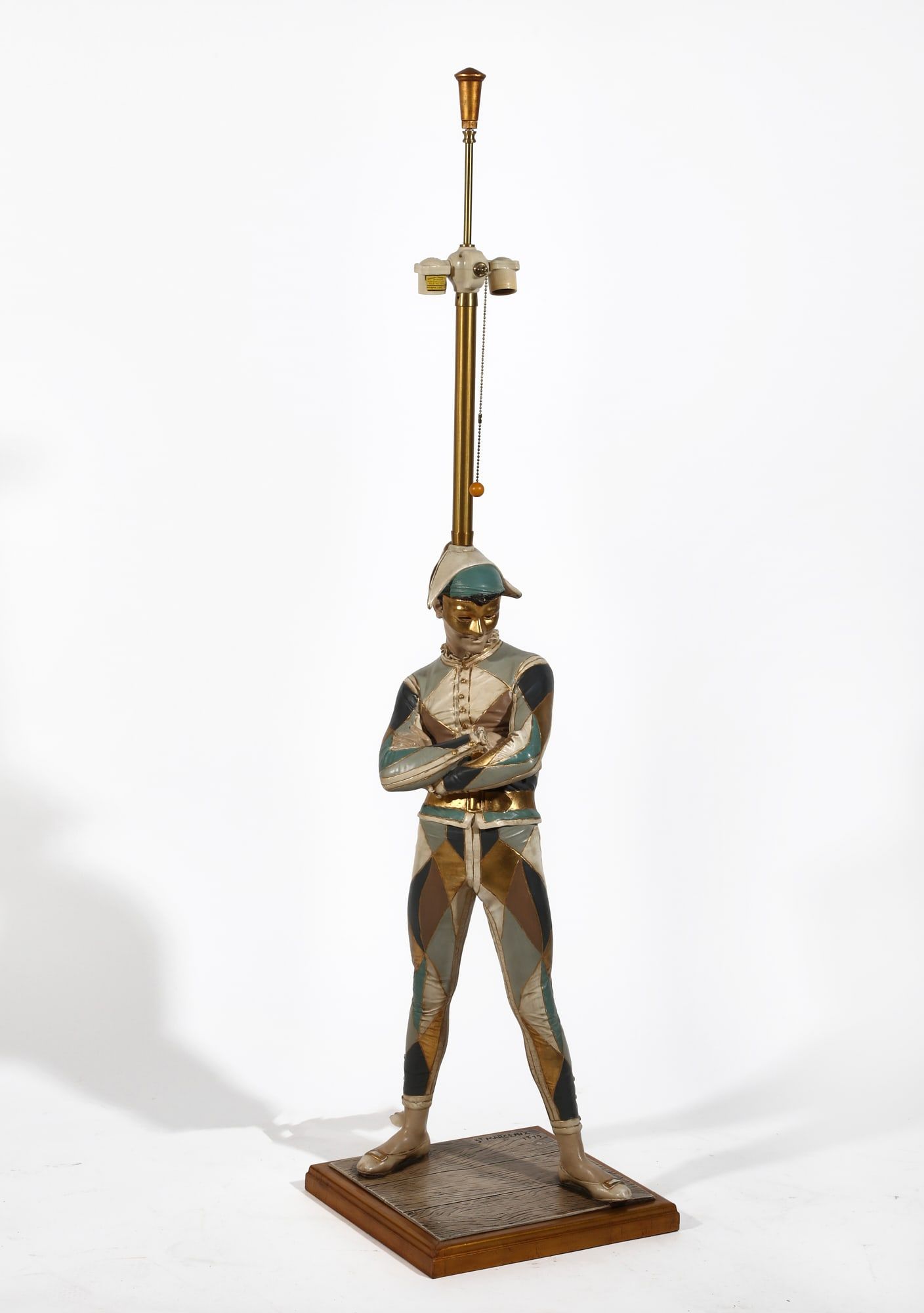 A LARGE PAINTED PLASTER HARLEQUIN
