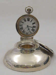 A large silver inkwell with Goliath