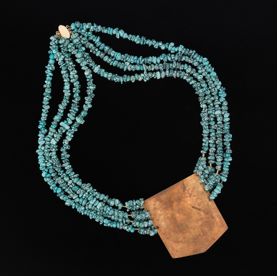 A Large Turquoise Bead And Brass