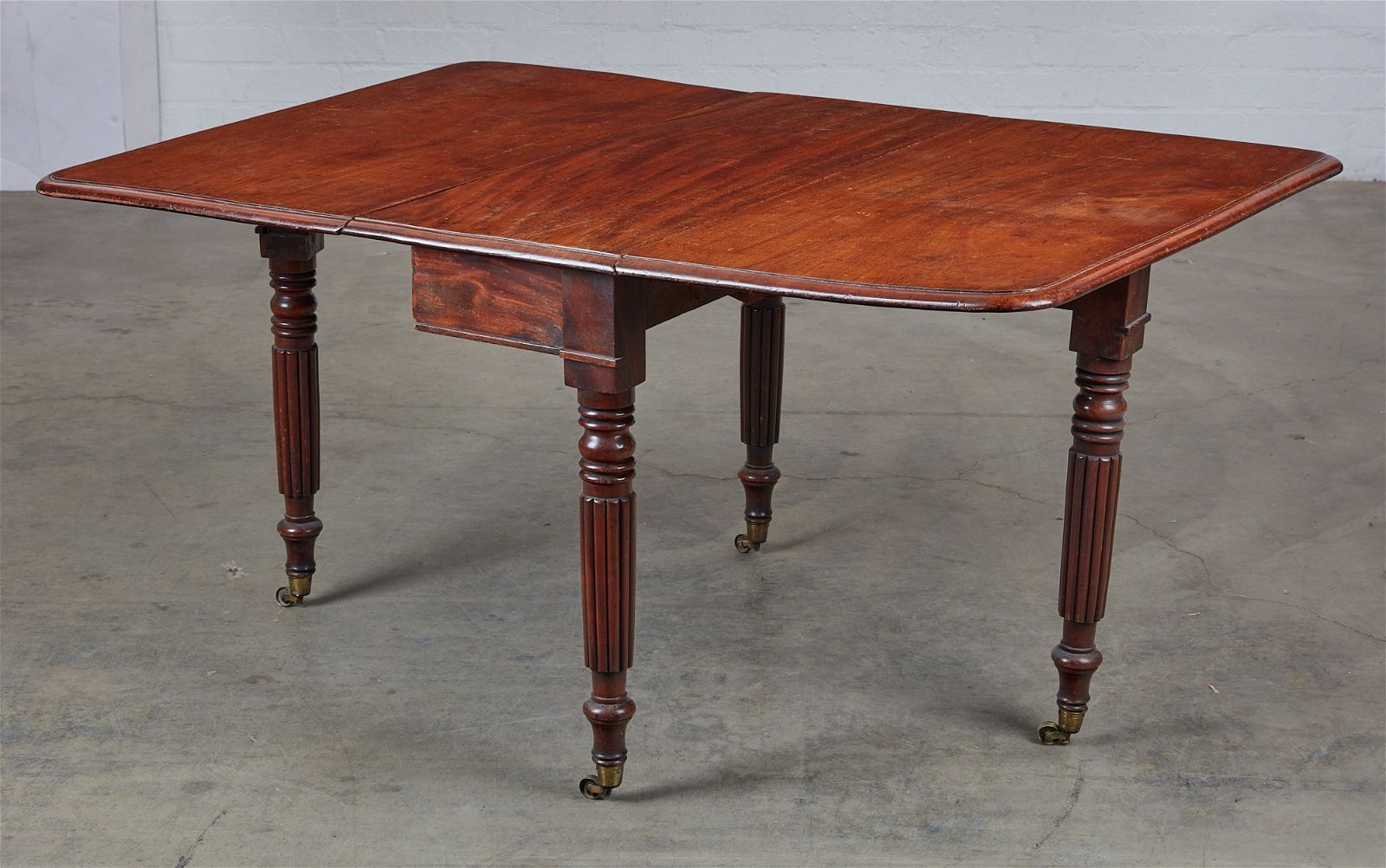 A LATE REGENCY MAHOGANY DROP LEAF