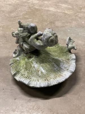 A lead bird bath with shell bowl
