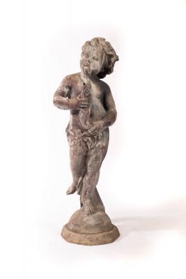 A lead figure of a boy with a fish,
