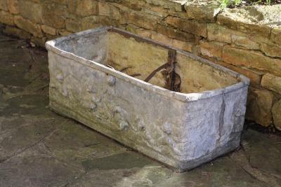 A lead trough moulded with figures,