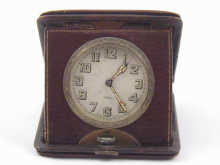 A leather cased travelling clock