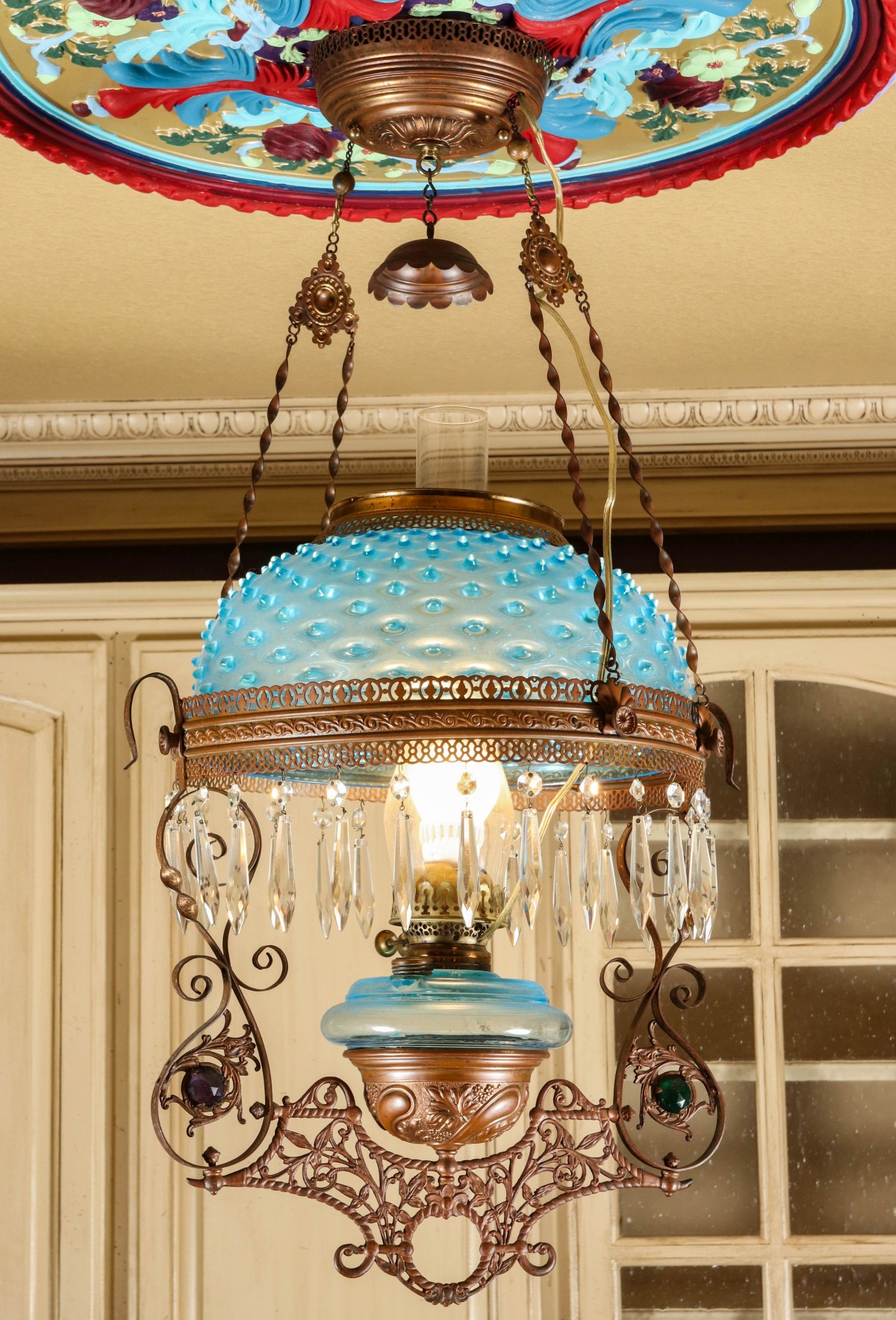 A LIBRARY LAMP WITH BLUE HOBNAIL