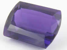 A loose polished amethyst measuring