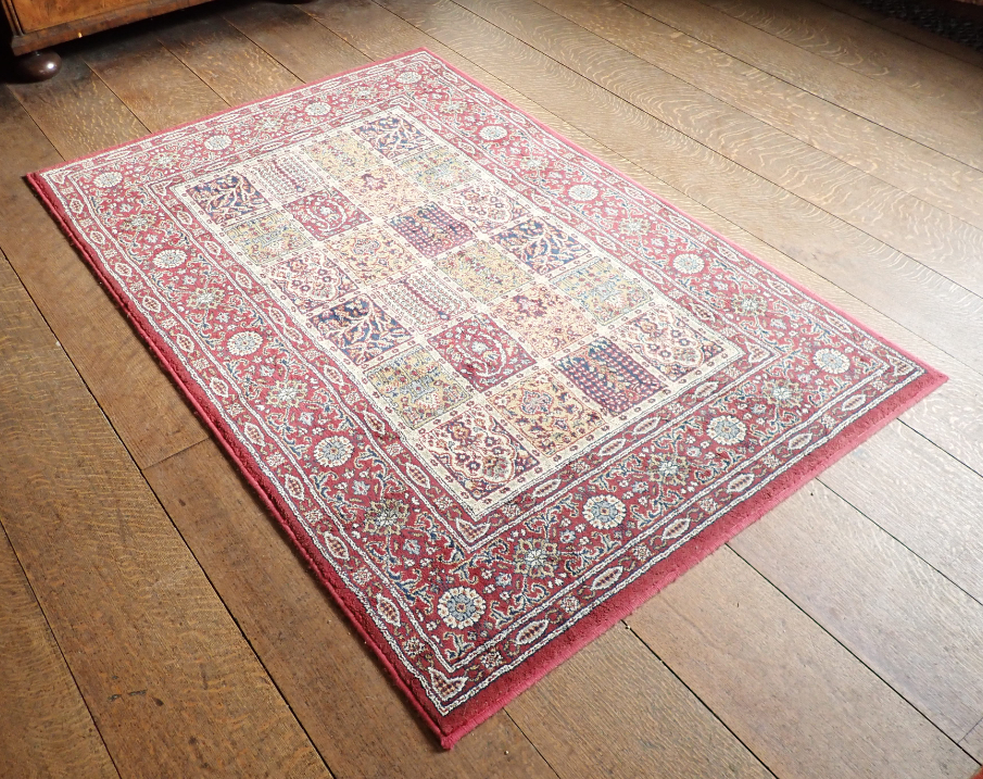 A MACHINE MADE RUG OF PERSIAN
