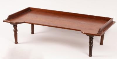 A mahogany bed tray on turned feet,