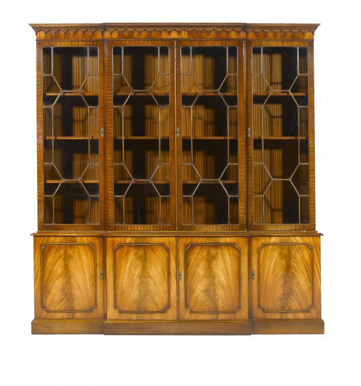 A MAHOGANY BREAKFRONT BOOKCASE in