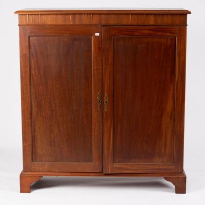 A mahogany cupboard enclosed by a