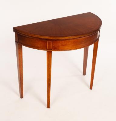 A mahogany D-shaped card table,