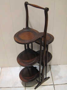 A mahogany folding cake stand