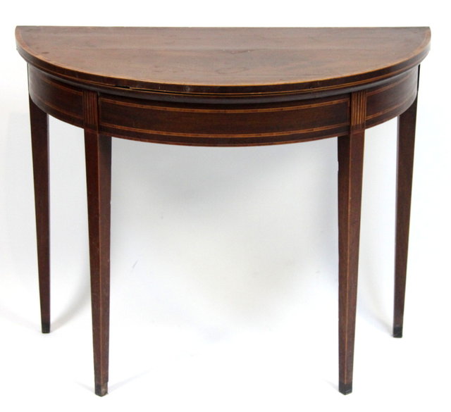A mahogany half-round card table