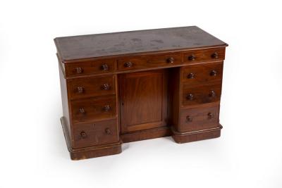 A mahogany kneehole desk fitted a
