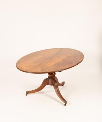 A mahogany oval breakfast table
