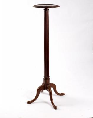 A mahogany plant pedestal with