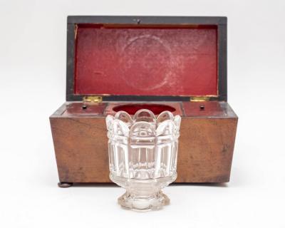 A mahogany tea caddy with fitted