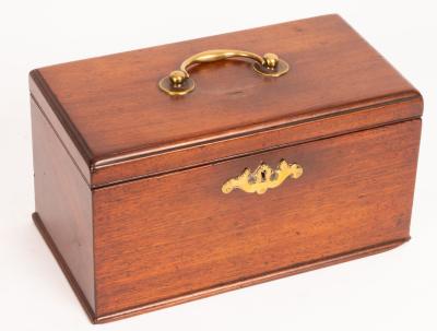 A mahogany tea caddy with brass