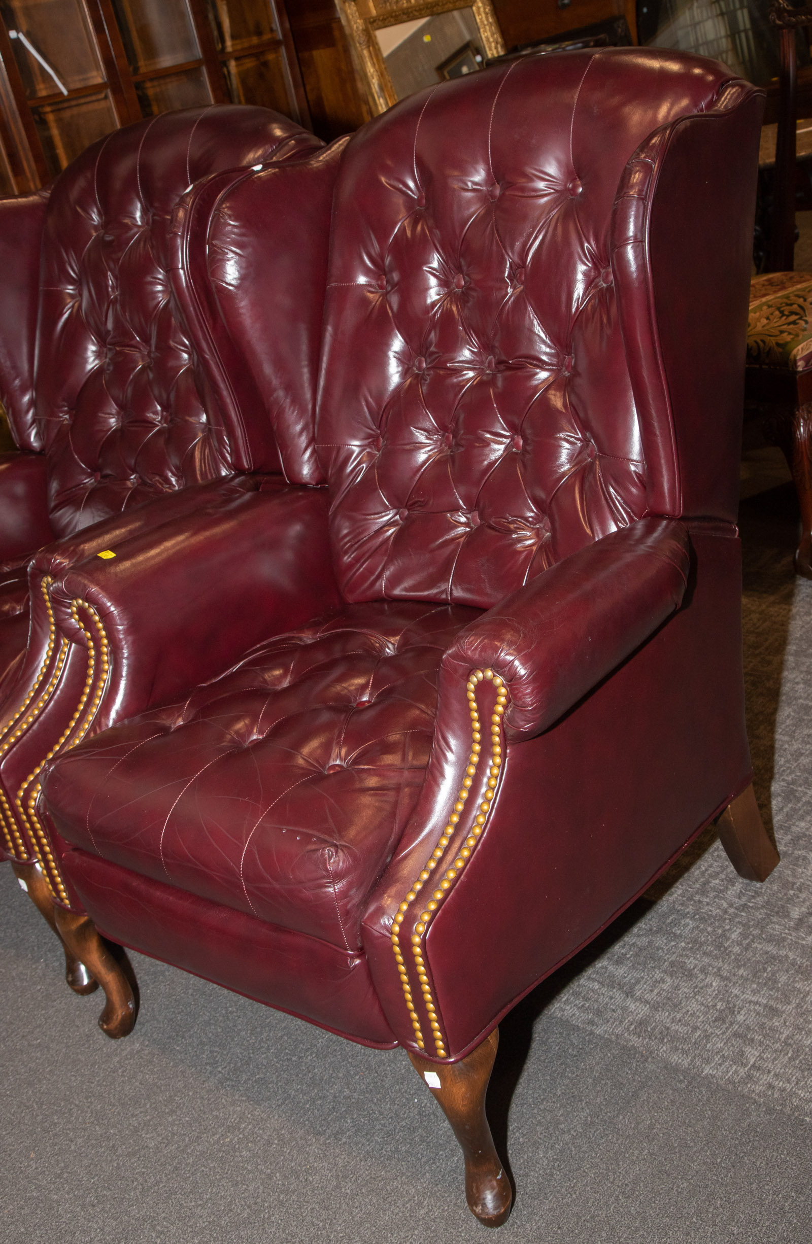 A MAROON LEATHER RECLINING WING