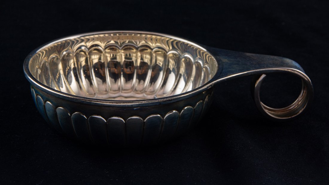 A MEXICAN TANE STERLING PORRINGER