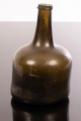 A mid 18th Century green glass wine