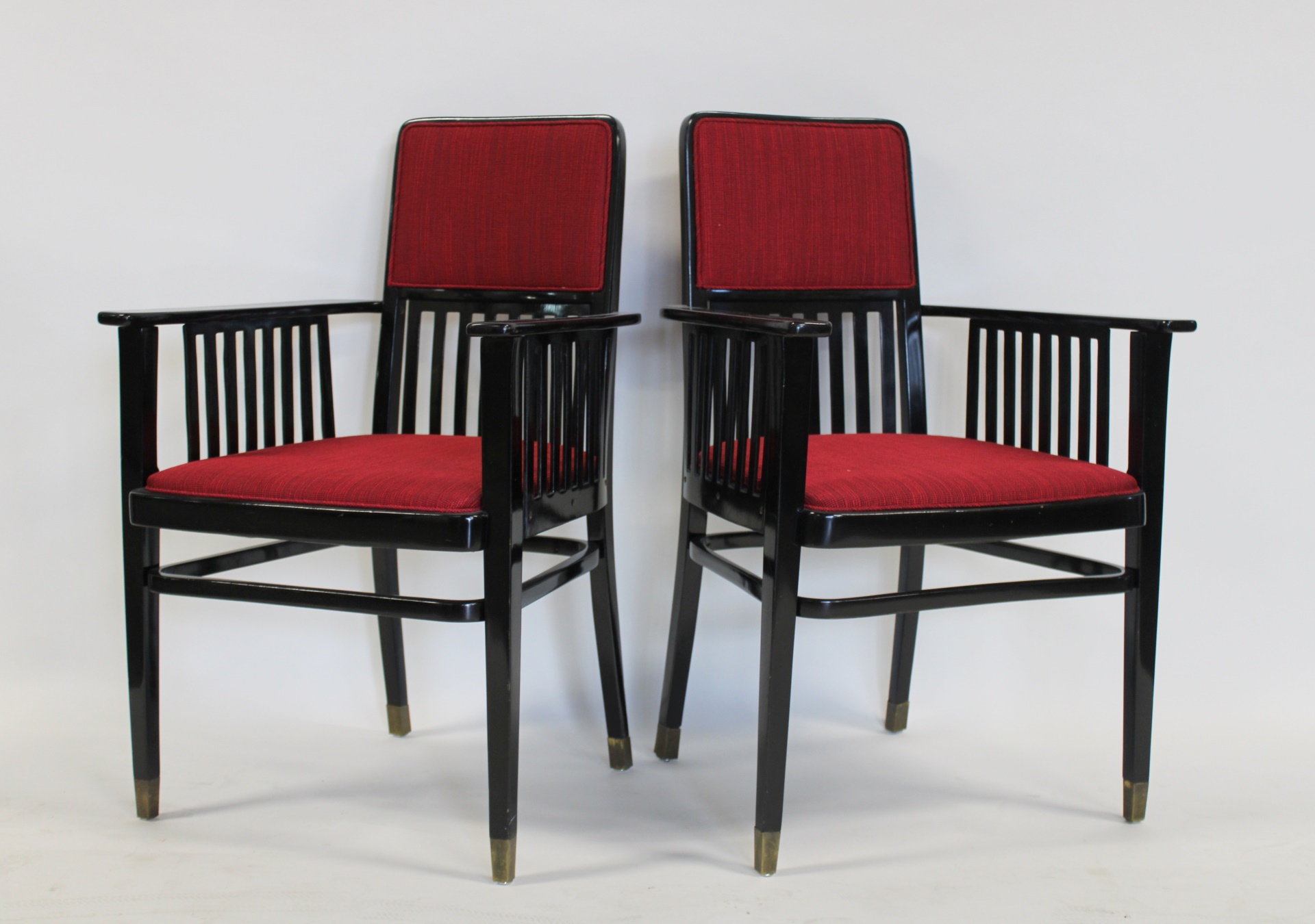 A MIDCENTURY PAIR OF EBONISED ARM